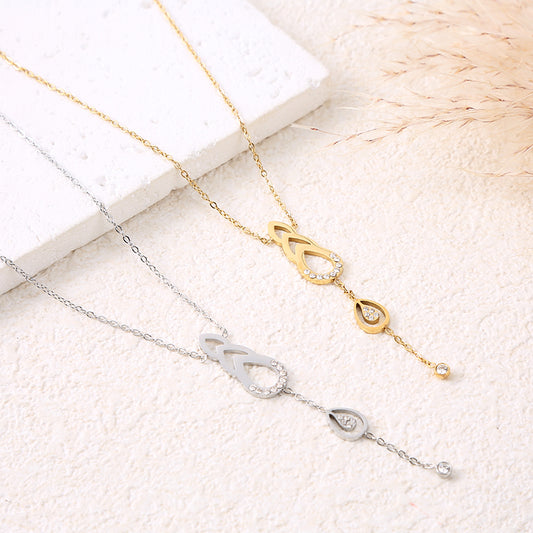 Collier chaîne dorée pendentifs avec gouttes ajourés et strass