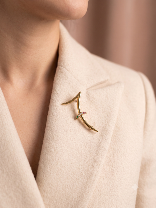 Broche design courbes croisées et strass multicolore