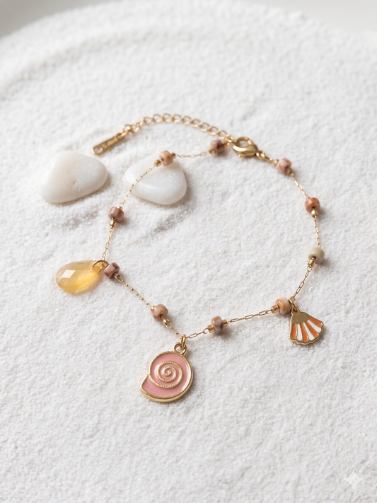 Chaîne de cheville dorée perles rosées et charms marins