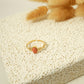 Golden ring with pink stone