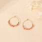 Boucles d'oreilles créoles avec pierres roses