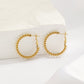 Braided hoop earrings with white stones