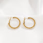 Braided hoop earrings with white stones