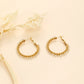Braided hoop earrings with white stones
