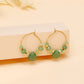 Boucles d'oreilles créoles avec pierres vertes