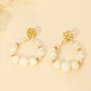 Hammered round earrings and white pearls
