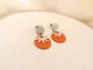 Orange earrings with silver flower