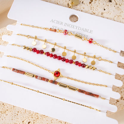 Multiple red beaded bracelets