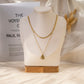 Double chain necklace with pendant and colored stone