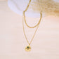 Collier double chaîne avec pendentif et pierre colorée