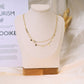 Collier double chaîne avec pierres grises