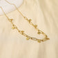 Golden link necklace with round hammered pendants