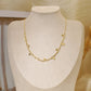 Golden link necklace with round hammered pendants