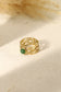 Wide ring with green stone