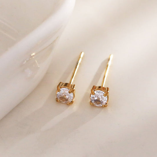 Simple golden earrings with rhinestones