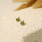 Golden stud earrings with green pearl