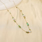 Chain necklace with green and white pearls