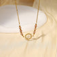 Collier avec chaîne avec pendentif soleil avec perles roses autour