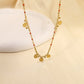 Chain necklace with orange details with round hammered pendants