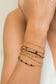 Multiple white thread bracelets