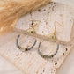 Drop earrings with sun in white stones
