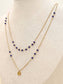 Collier double chaîne avec perles rouges