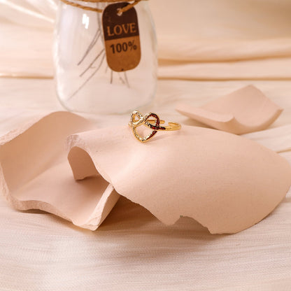Golden heart ring with strikethrough