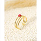 Triple line golden ring with red stone