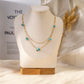 Double chain necklace with 5 golden green stones