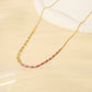 Golden necklace with pink pearls