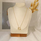 Golden crossed circle necklace