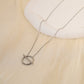 Golden crossed circle necklace