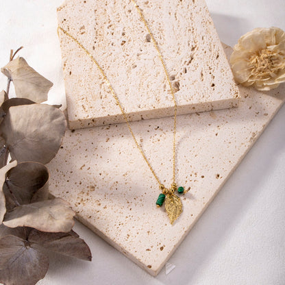 Necklace with leaf pendant and pearl in gold color