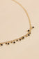 Necklace with mini gold black pendants