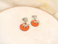 Orange earrings with silver flower